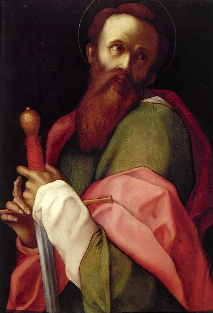A bearded man with a halo and colorful robes holds a sword in his hands and looks to his left.