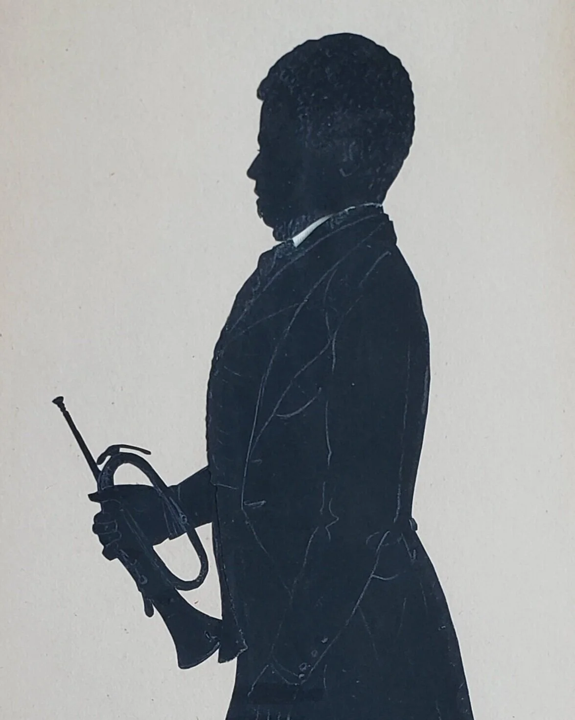 A black silhouette of a man holding a trumpet by his side against a white background.