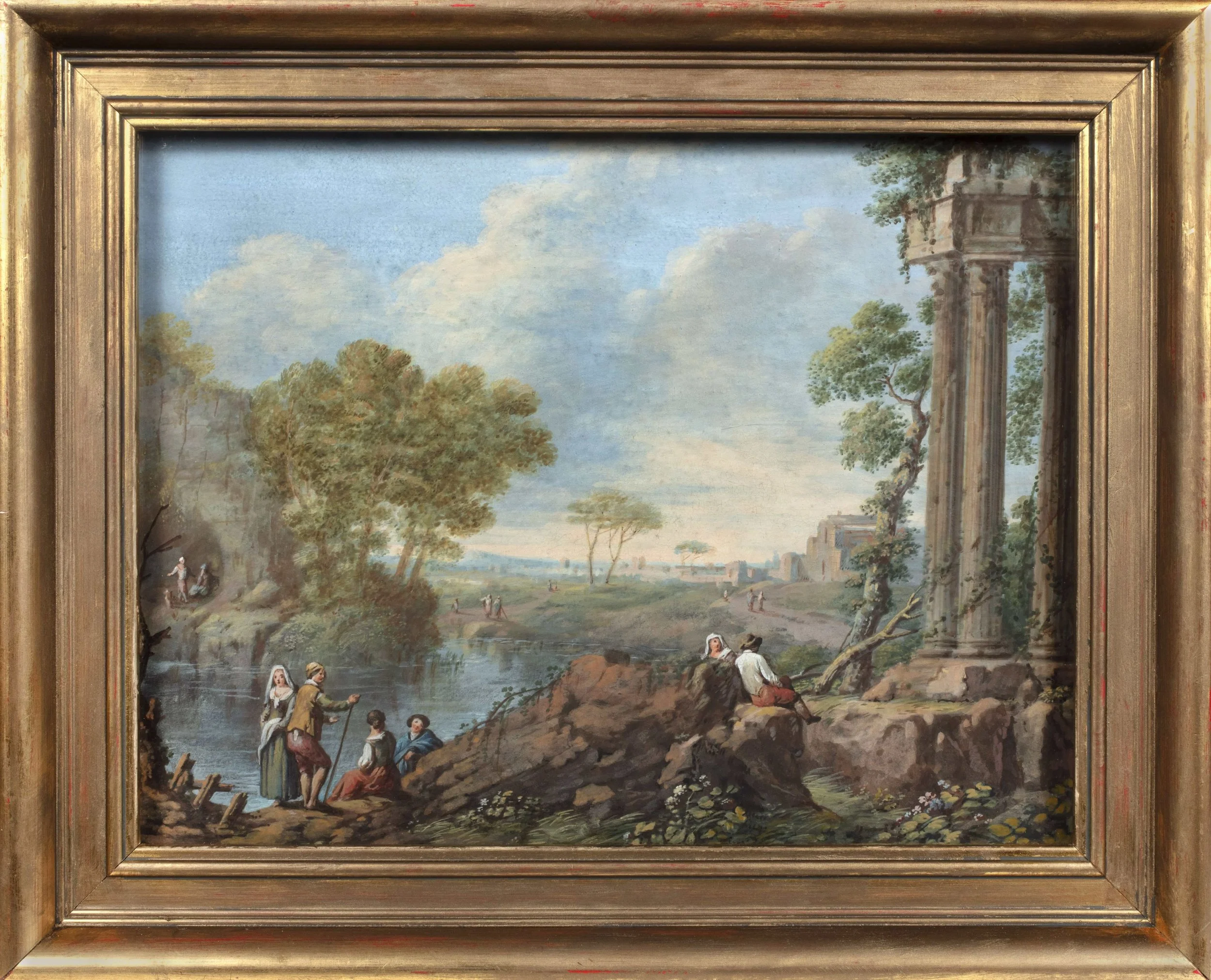 People in natural landscape and ancient ruins by the water