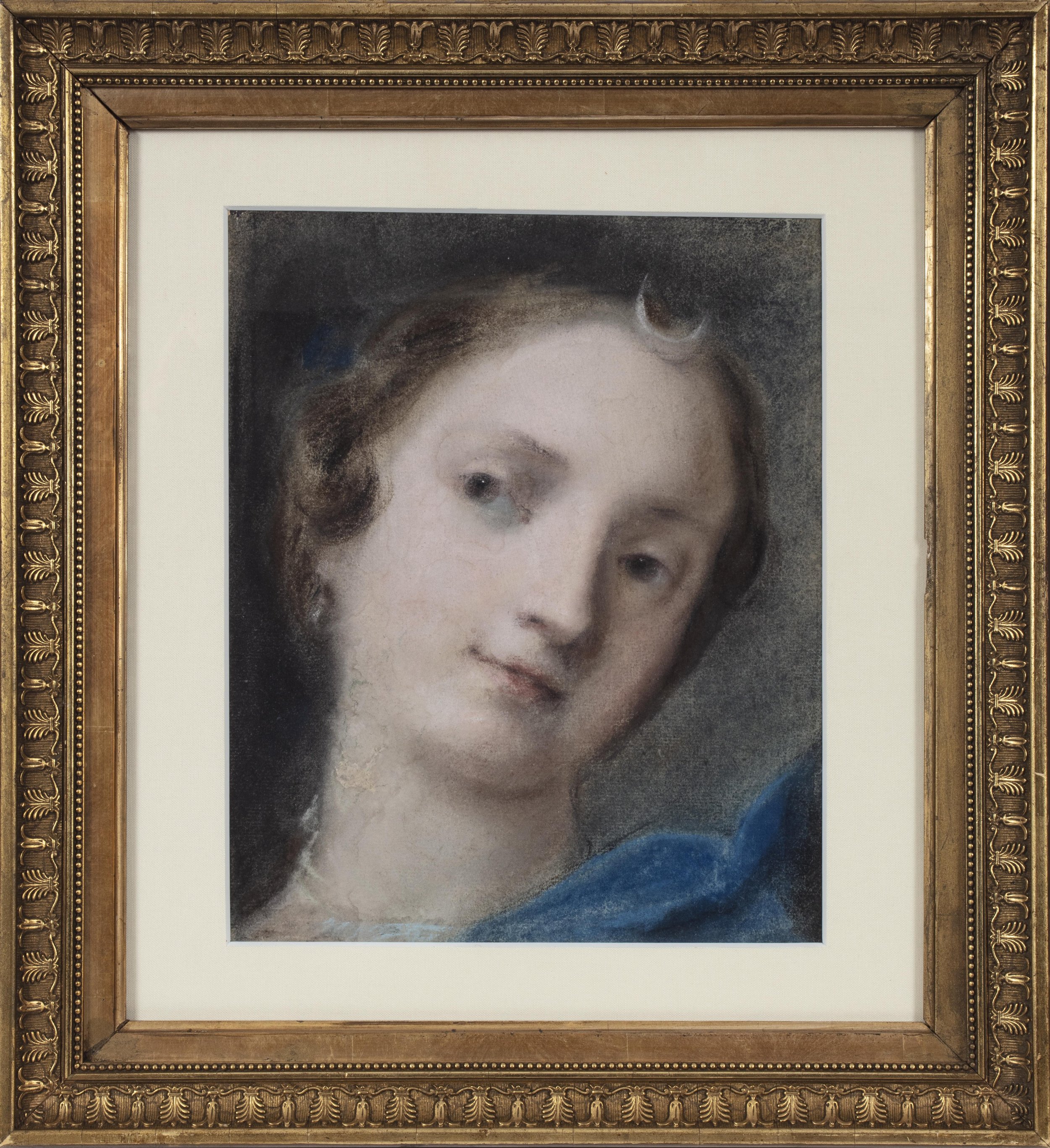 Close up of a young woman with half-moon symbol on her head