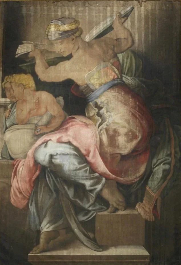 A woman seated holds a book