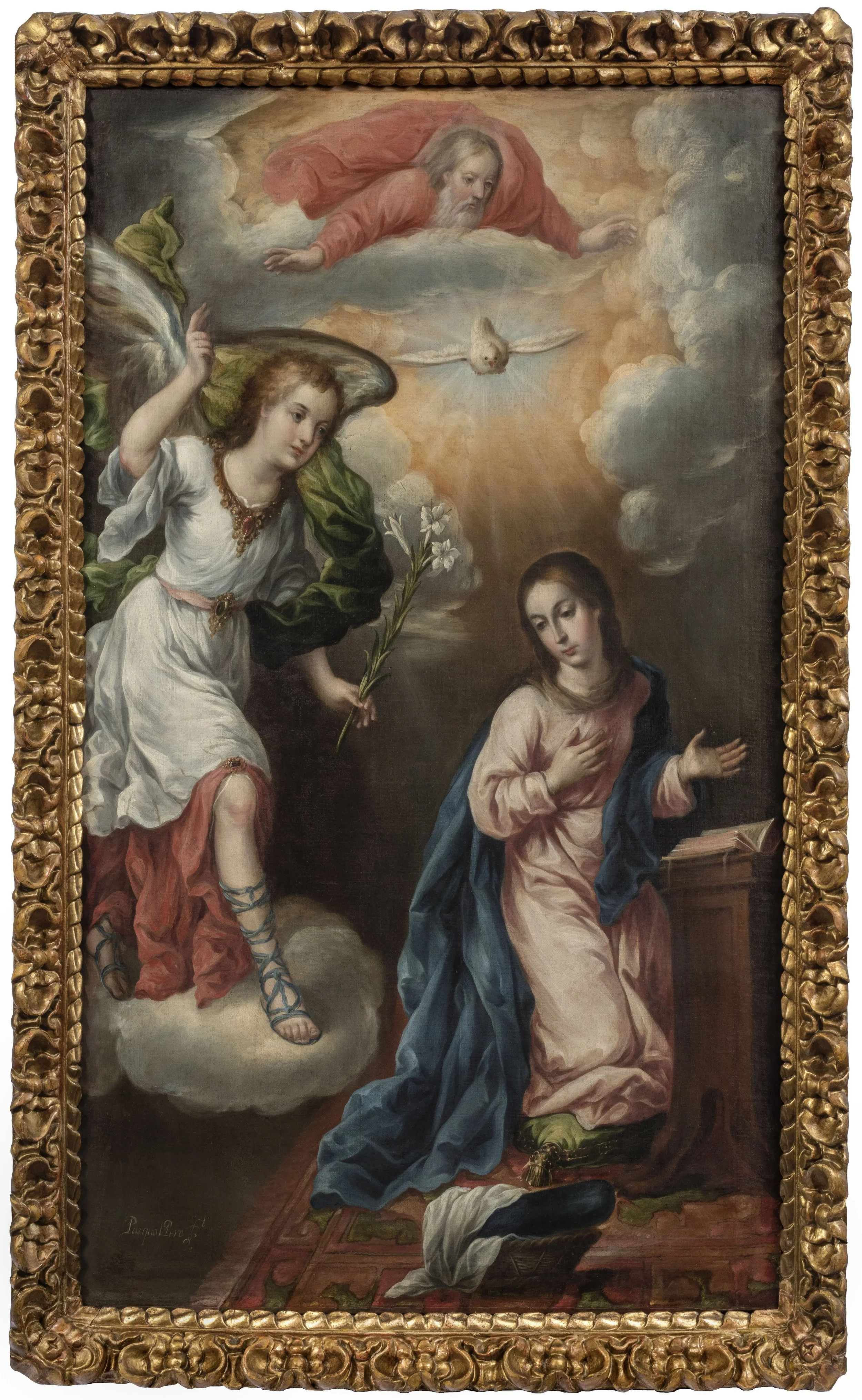 Ornate gold-framed painting depicting the Annunciation with angel holding lilies, Virgin Mary kneeling, dove, and heavenly figure above.