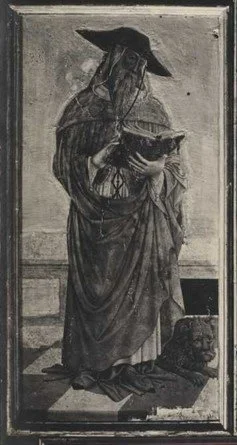 A black and white image of an elderly bearded man with a hat and a long robe holds a book in his hands while a small lion sits on the right side.