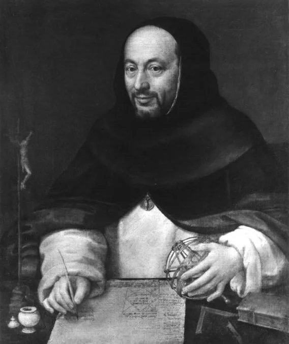 Male scientist wearing a white robe and a black hooded cape. He is writing while holding an astronomical globe and has a crucifix nearby.