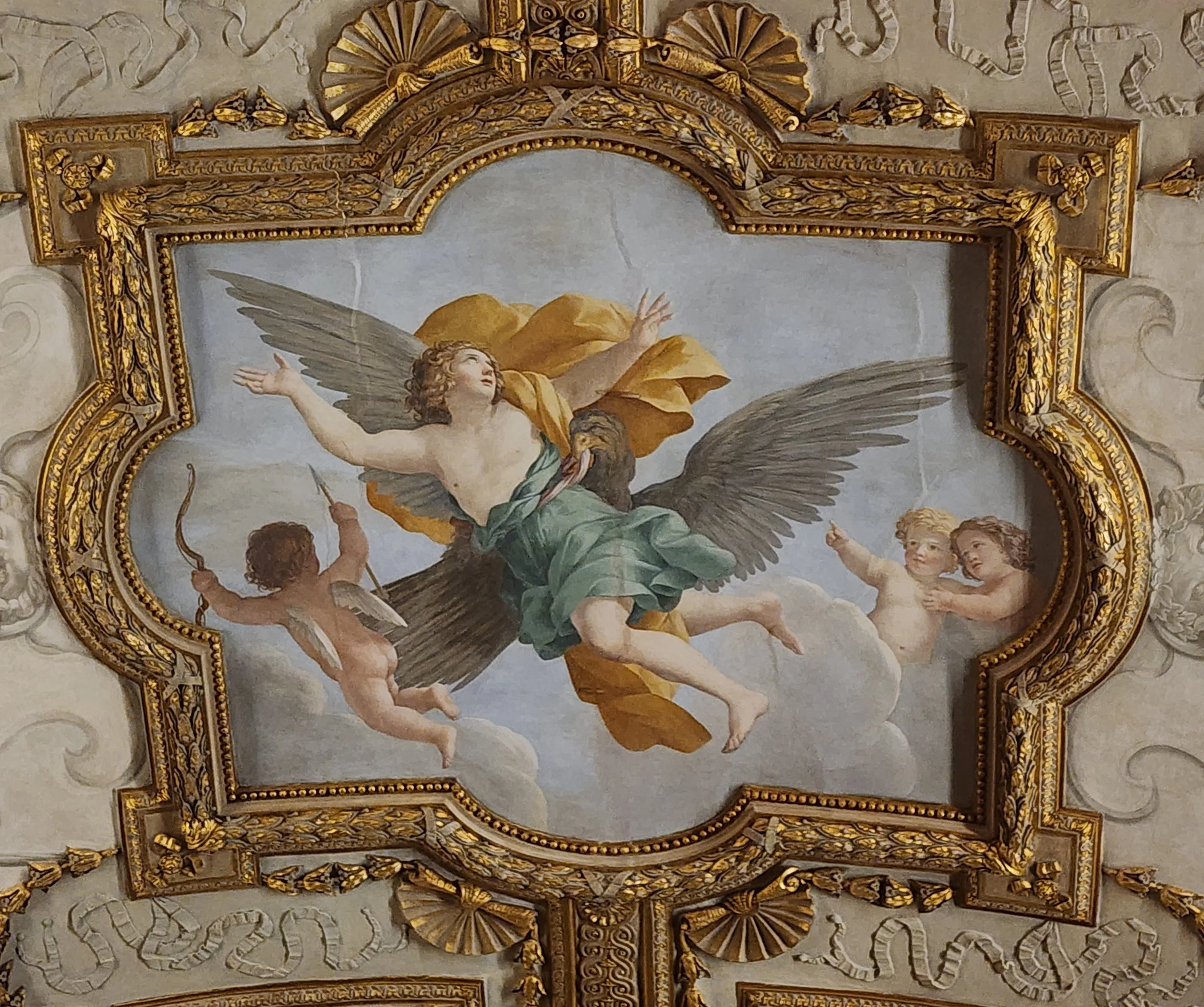 Winged goddess flying through the air with three putti in the background.