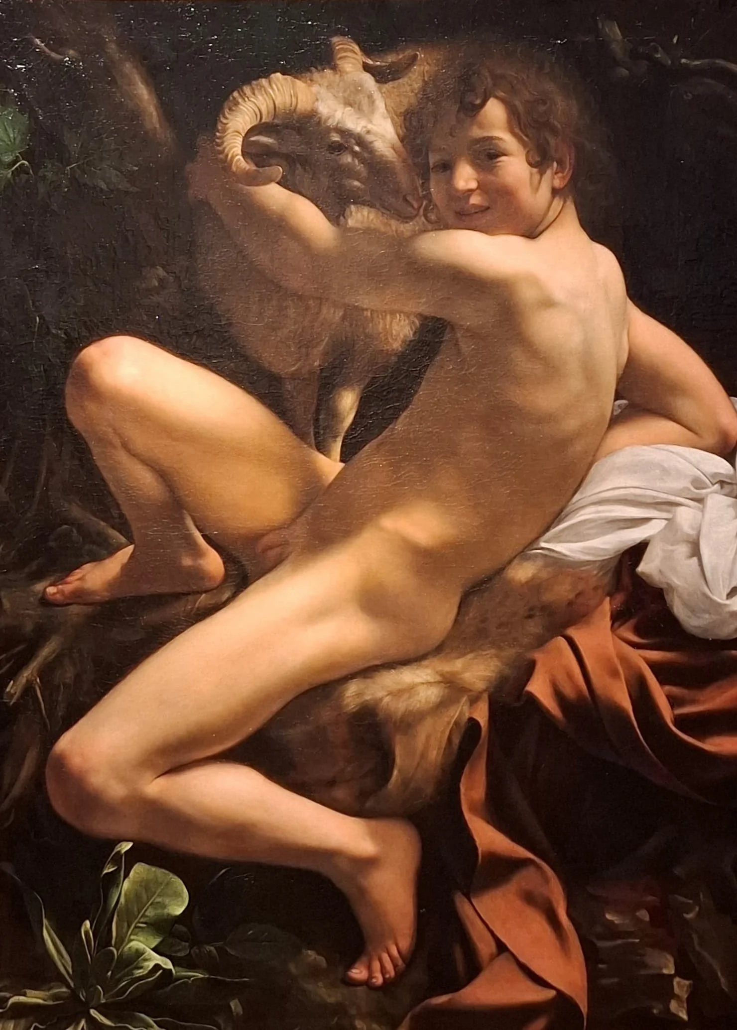 Nude male figure in a landscape holding a ram.