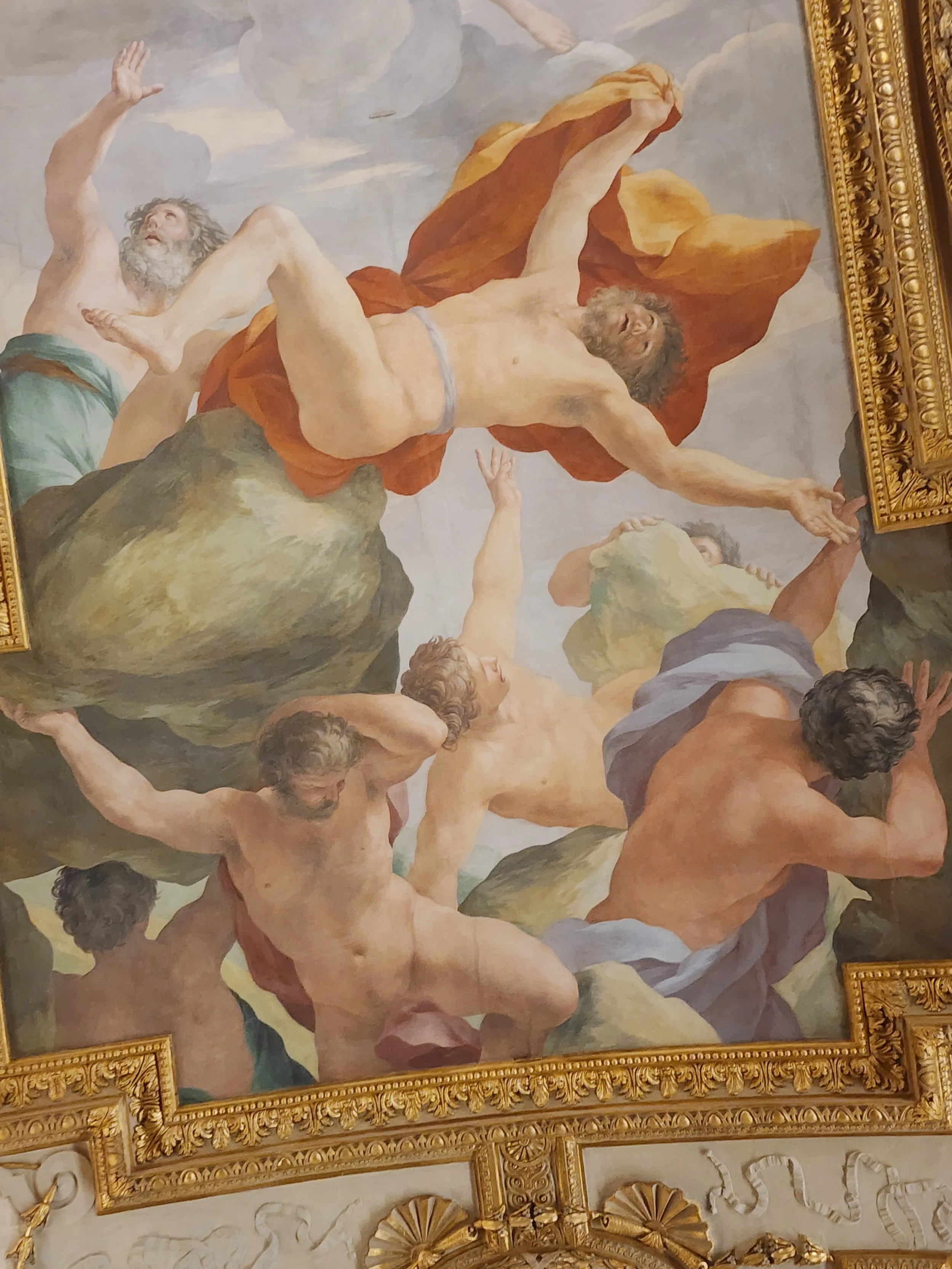 Semi-nude male figures battling in the clouds.