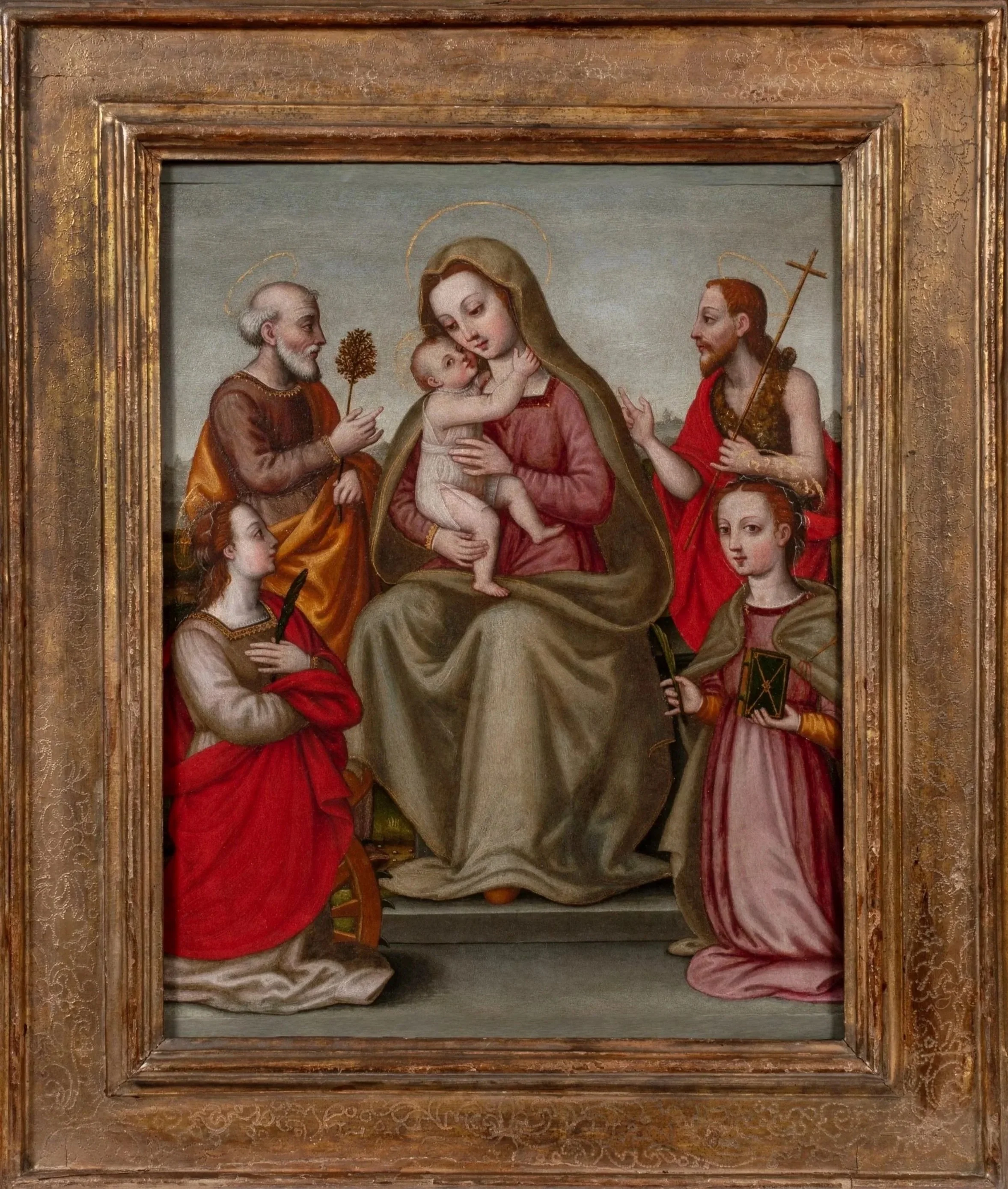 The Virgin Mary holding the Christ Child and surrounded by two male saints and two female saints in an outdoor setting.