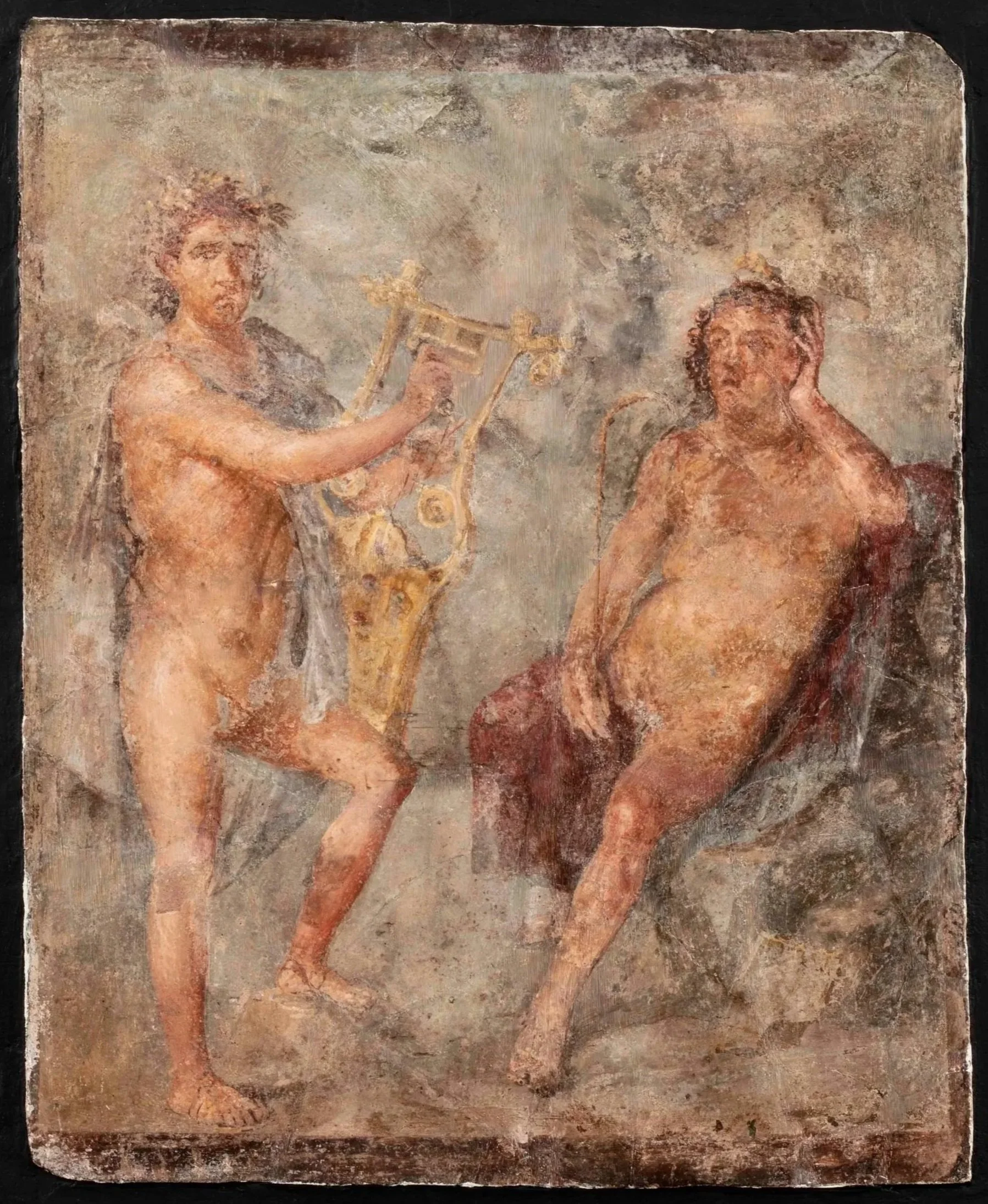 A nude figure standing and playing a lyre and a seated nude figure resting his head on his hand.