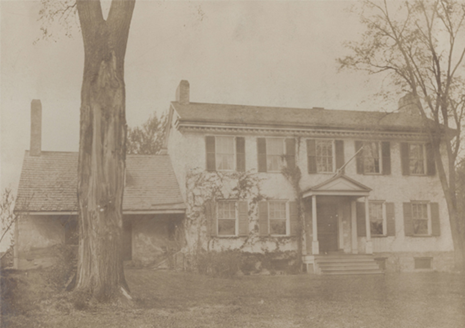 Old photo of a house with trees