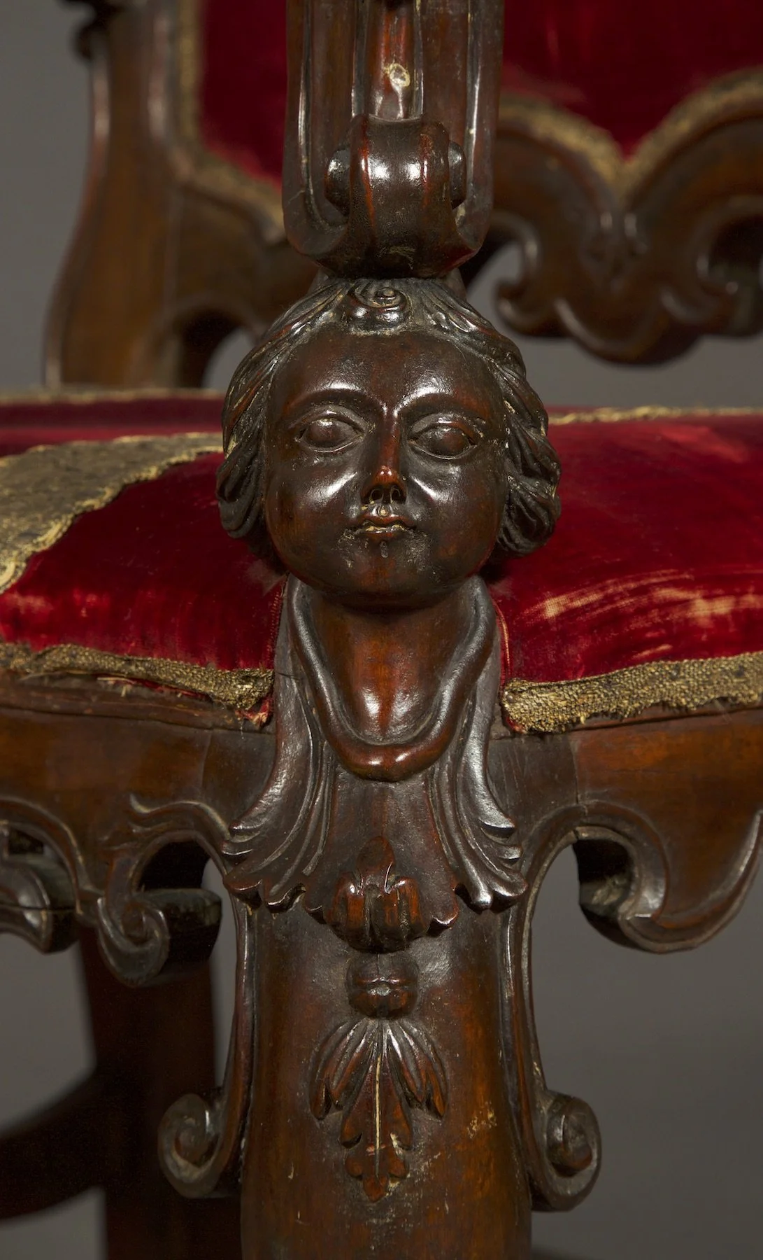 Close up detail of the cherubic bust decoration on the chair