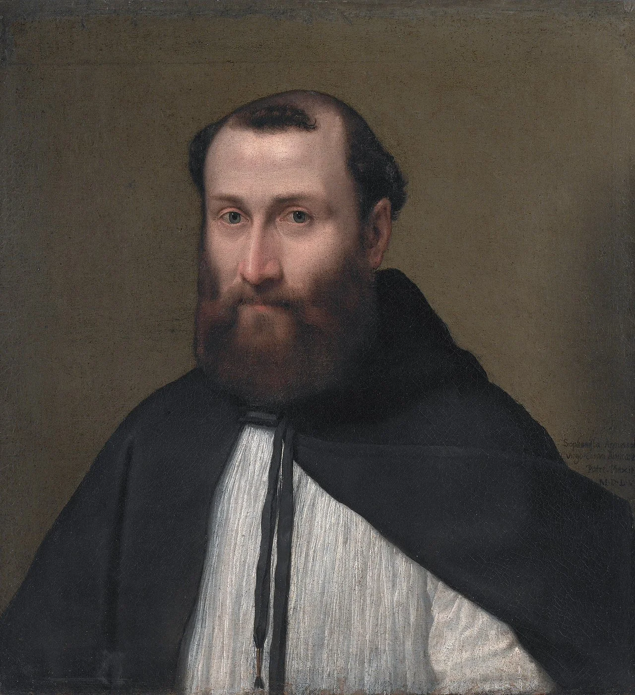Bearded man wearing a white robe with a black cloak.