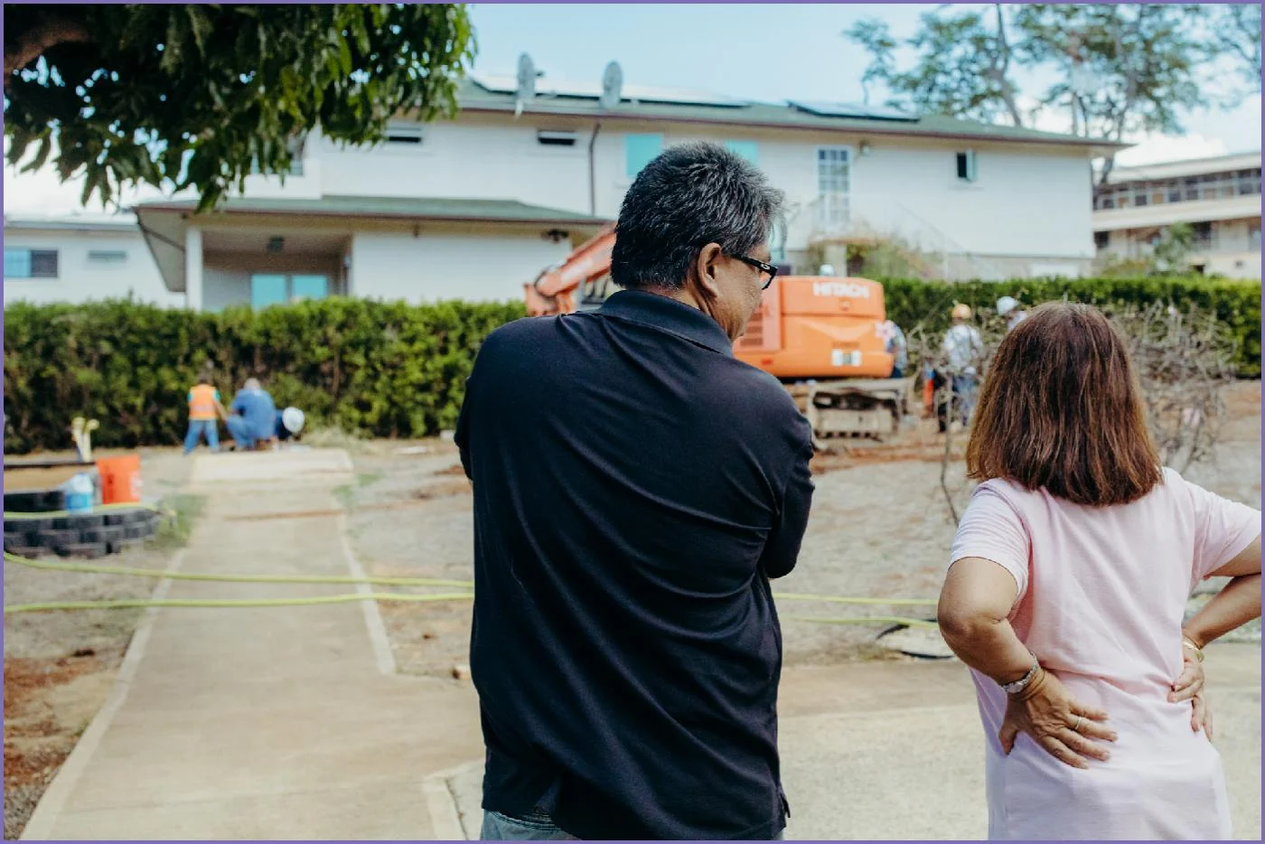Executive Director of HUGS Foundation, Joan Naguwa watching crews from Hensel Phelps and HELIX Electric demolish an old playhouse structure 
