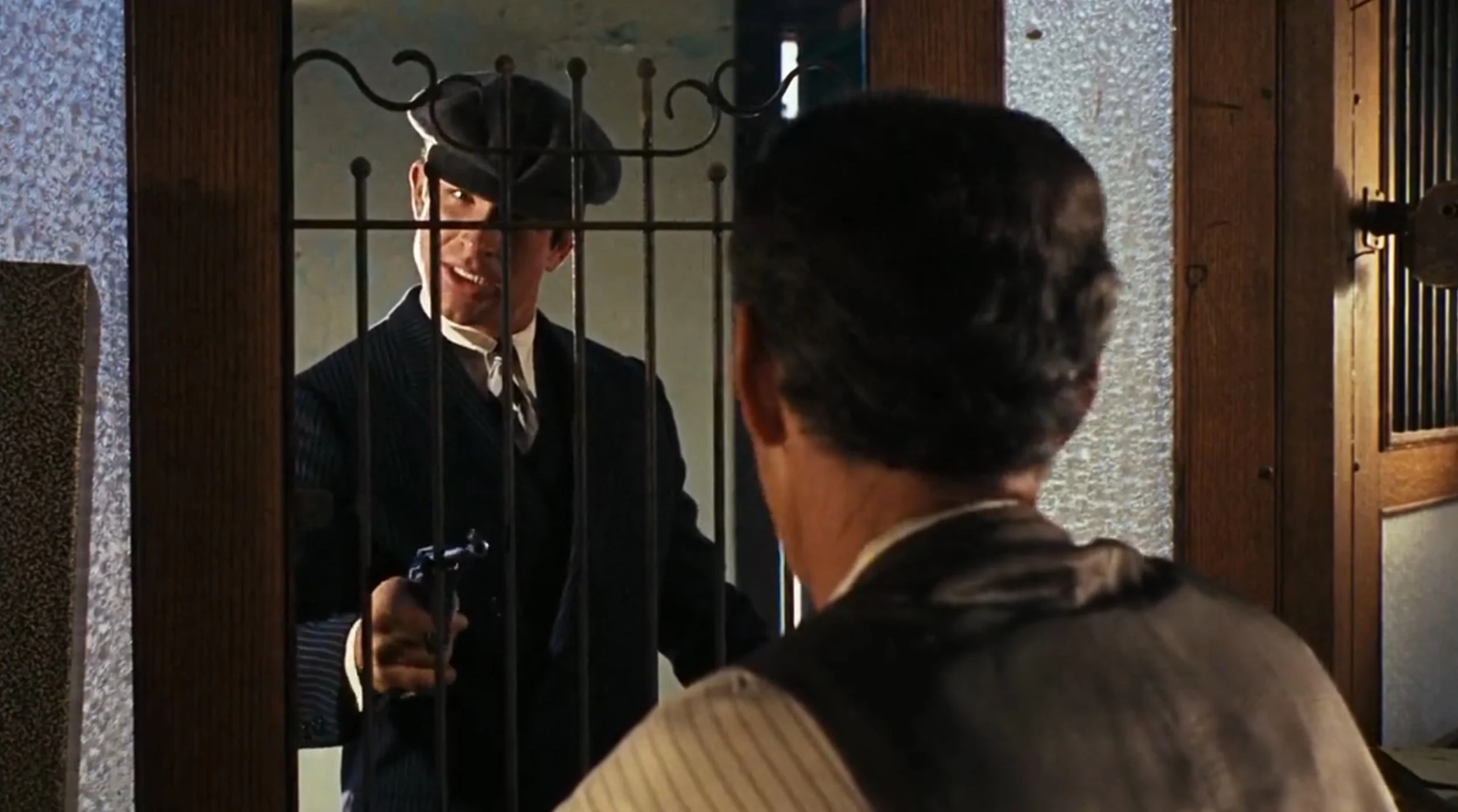Beatty: Navy three-piece suit with chalk stripe, shirt, silver tie and newsboy cap.