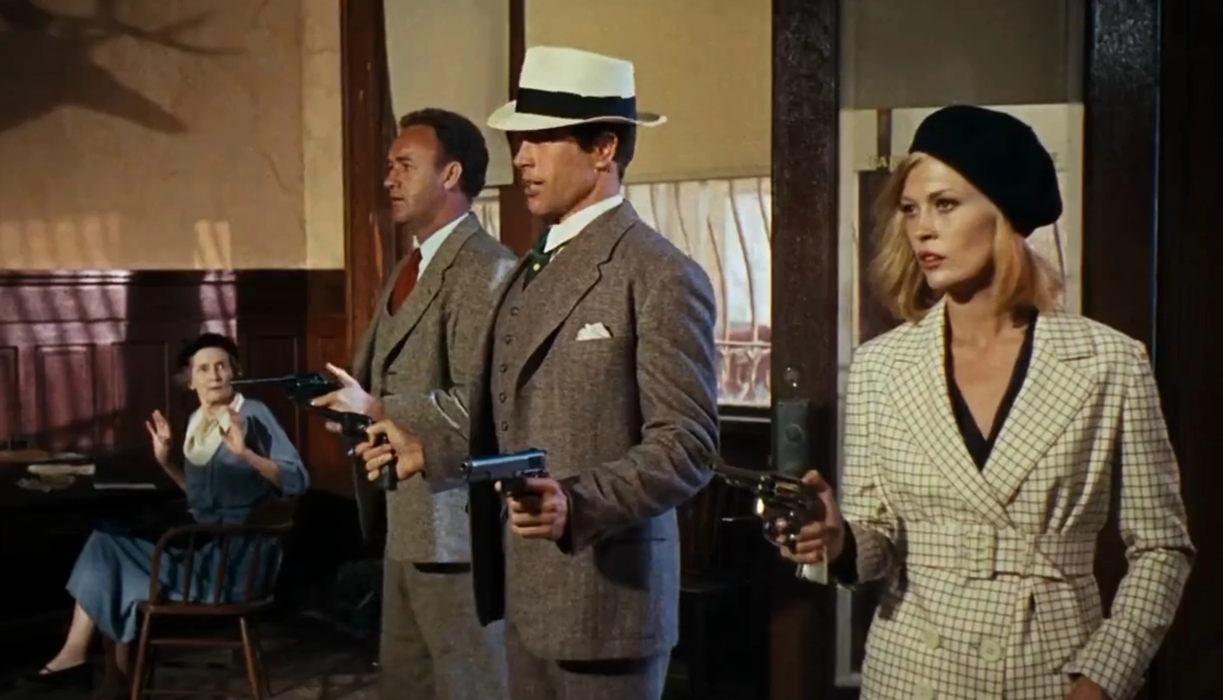 Beatty: Gray three-piece suit, white dress shirt, white fedora and dark tie. Hackman: Brownish gray hopsack three-piece suit and brown tie.