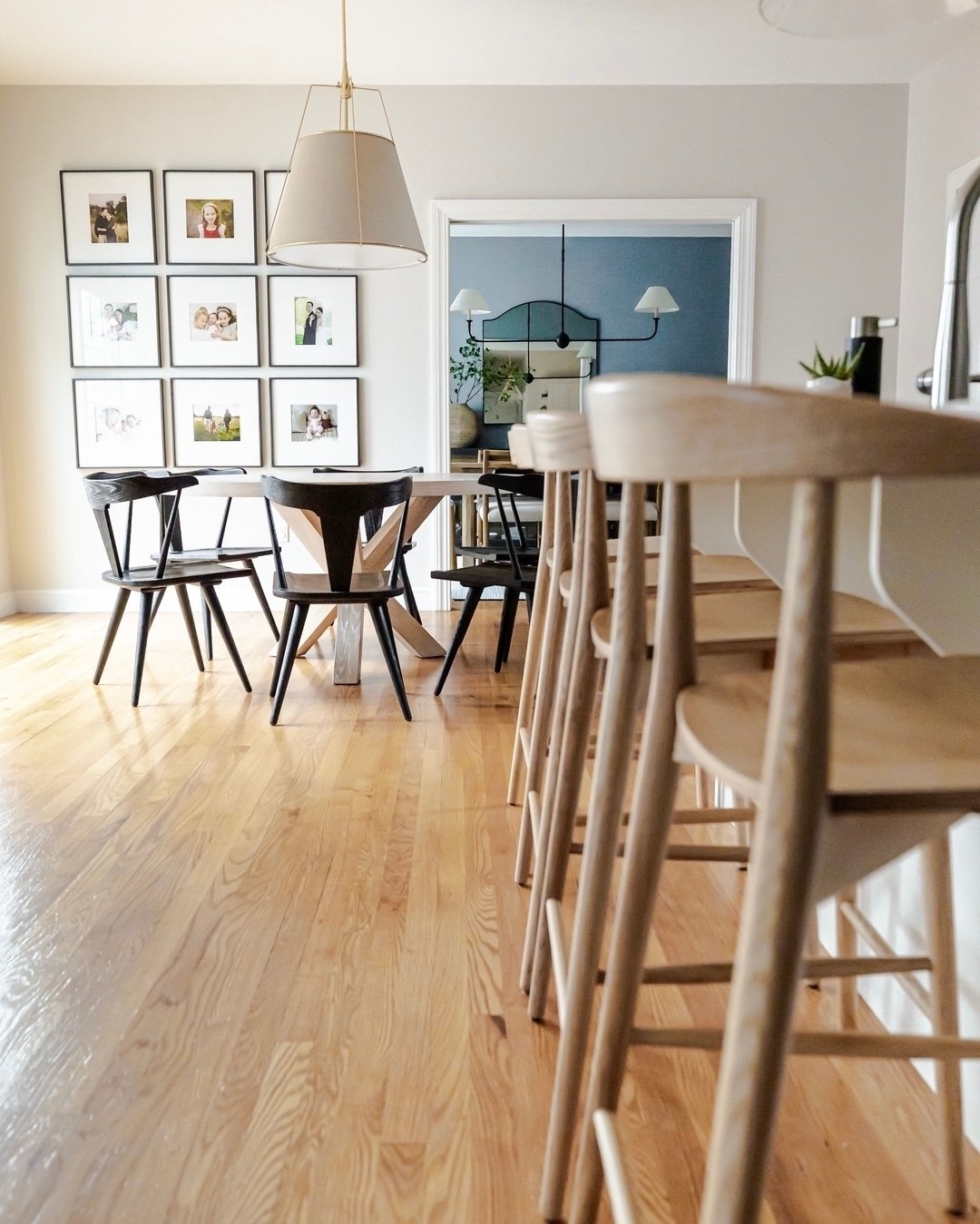 We highly recommend mixing styles of dining chairs and counter stools in an open concept space. Matching everything can get boring. It also misses an opportunity for layering design elements and deepening the style story of your home. That said, we a