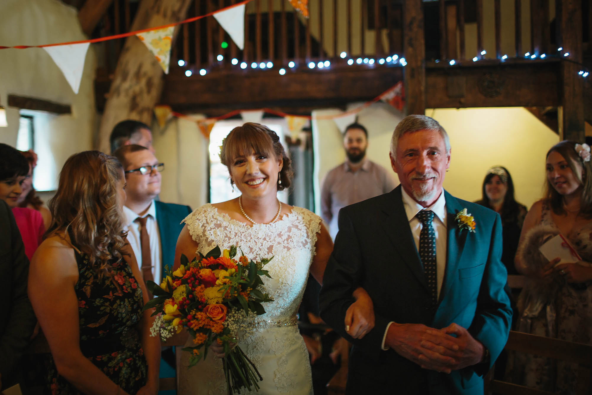 Bride and father walk down the aisle at Craven Arms Cruck Barn wedding