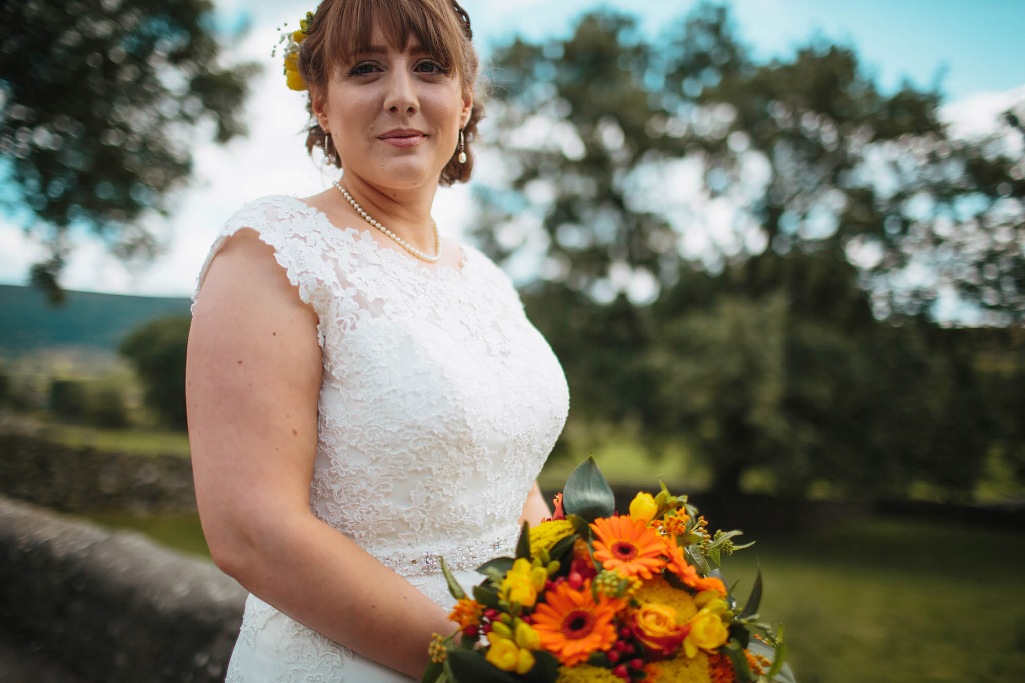 Bride poses with her bouquet in Yorkshire Dales