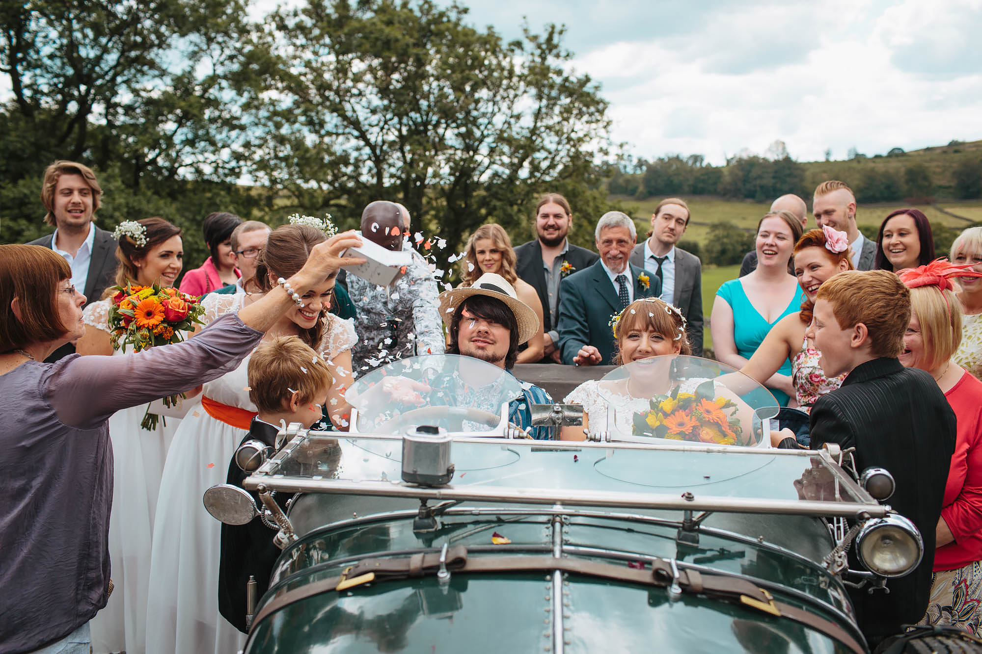 Bride and groom in a vintage car at a Yorkshire dales wedding