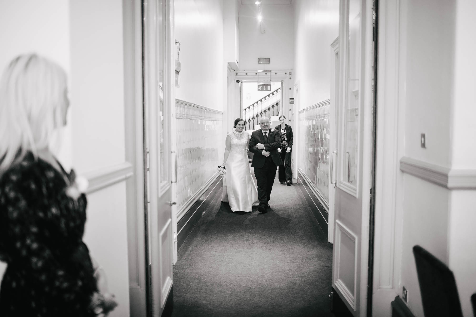 Bride and father walk down the aisle on her wedding day