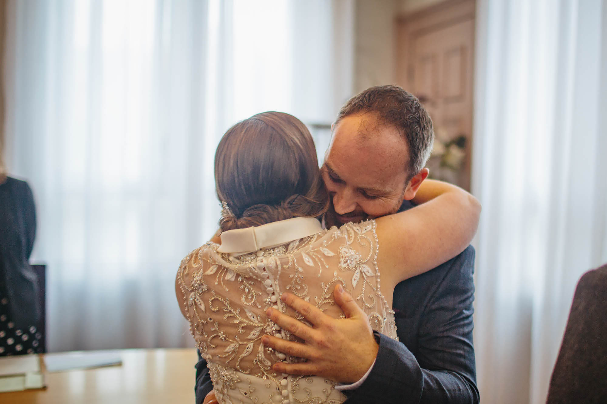 Bride and groom hug at a Leeds Town Hall wedding