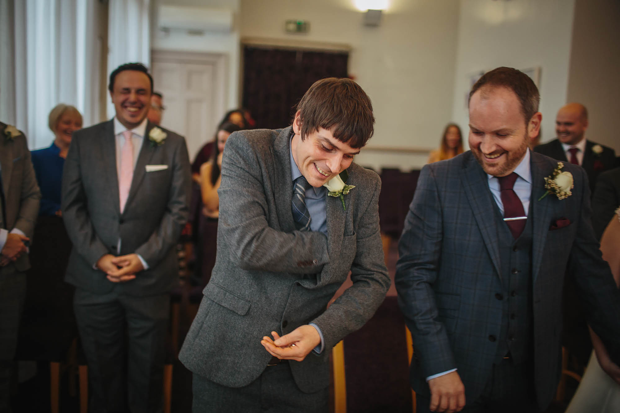 Best man reaches for the ring at a wedding ceremony in Leeds Yorkshire