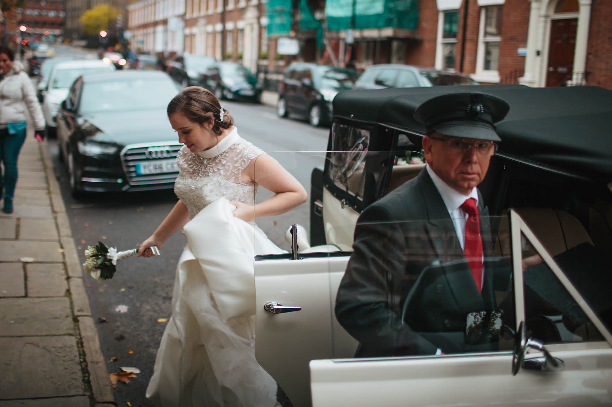 Bride getting out her wedding car in Leeds Yorkshire