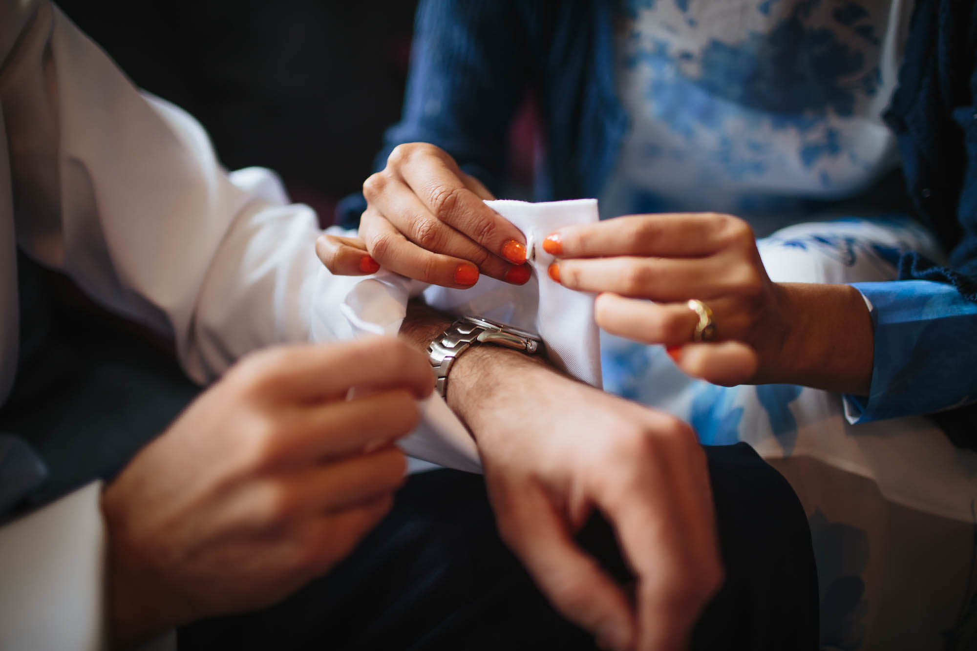 Groom has help fastening his cufflinks in Harrogate