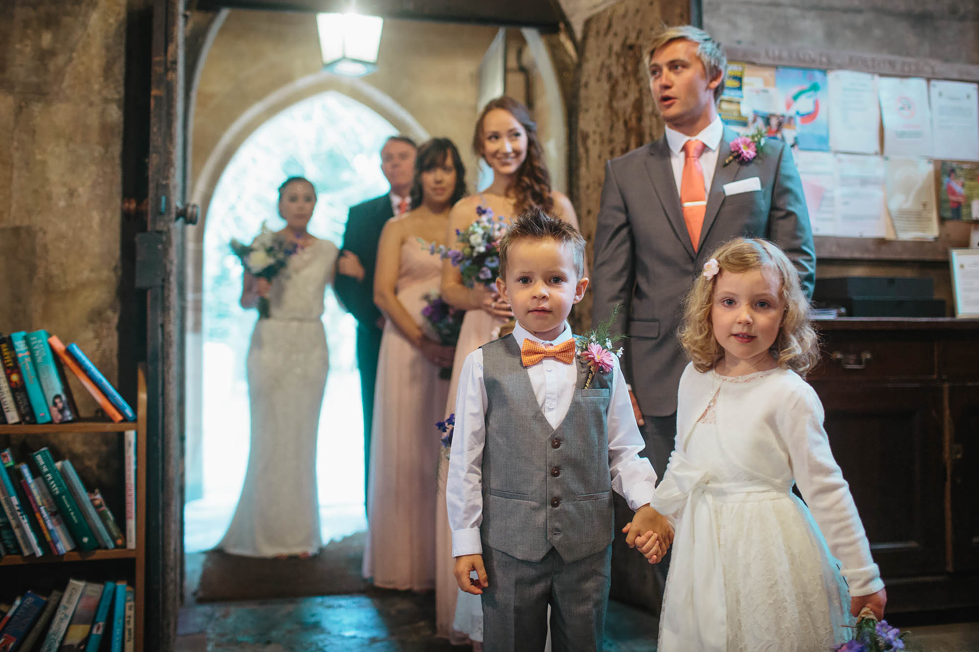 Boy and girl holding hands at a church wedding