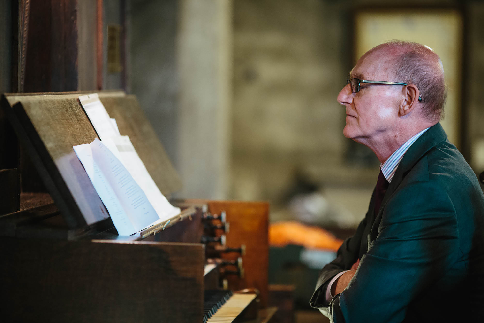 Church organist looks at his music during the wedding ceremony