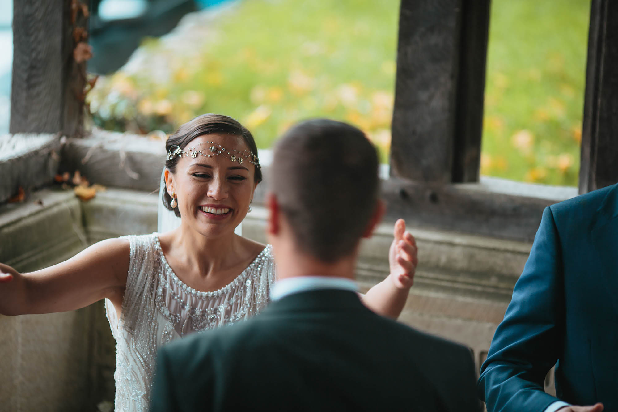 Bride laughing and greeting guests at her wedding in Yorkshire