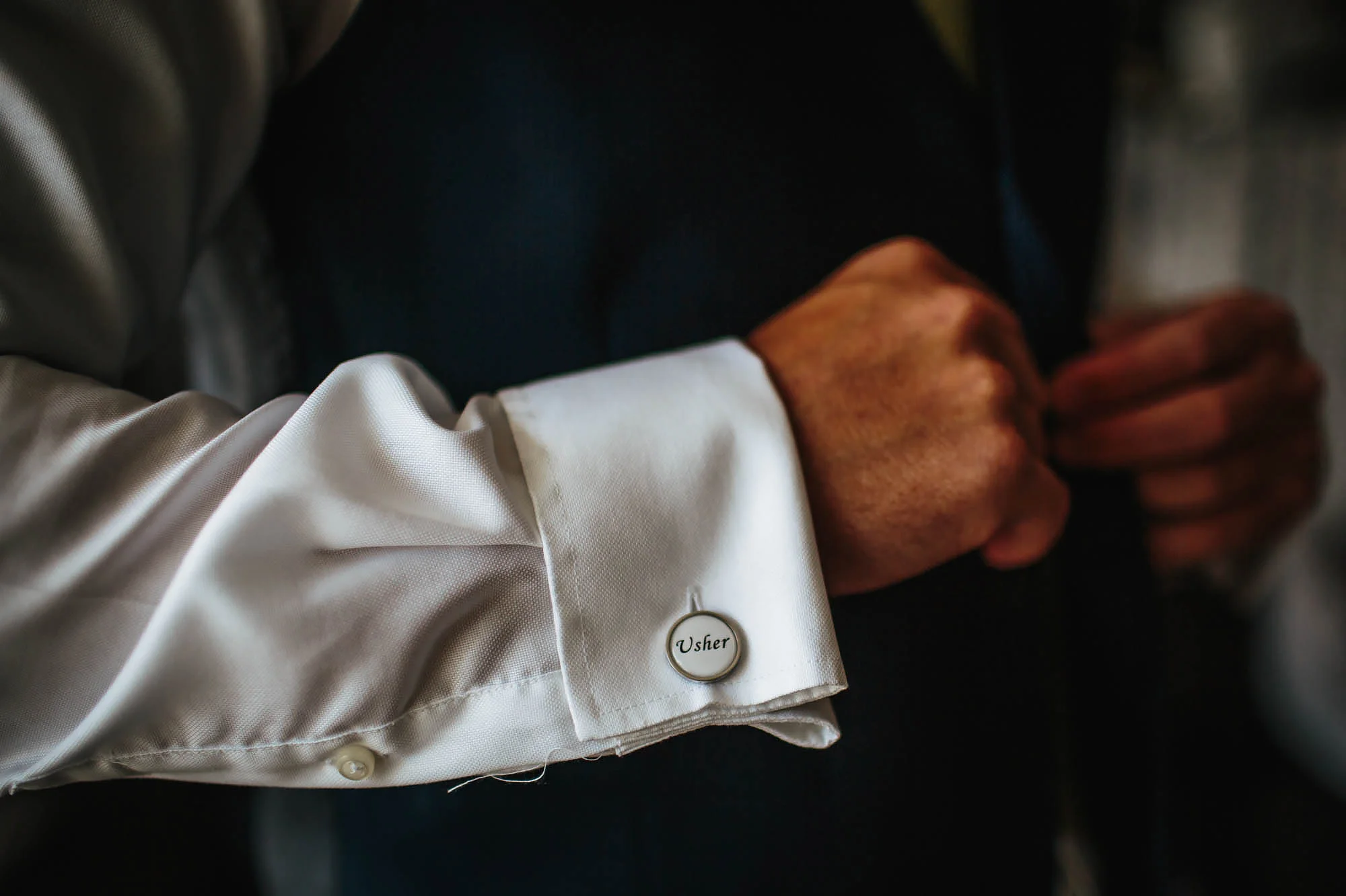 Usher wearing named cufflinks close up