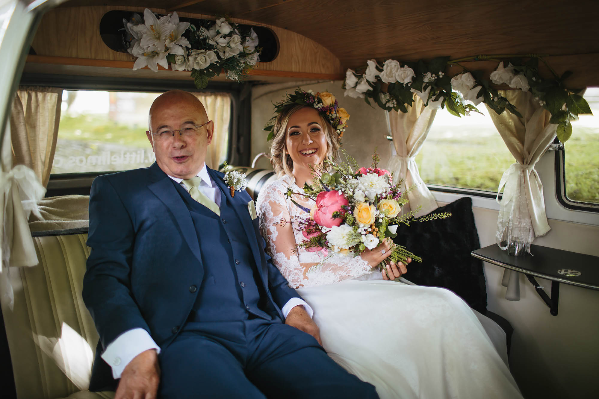 Bride and father arrive in VW camper van at a wedding