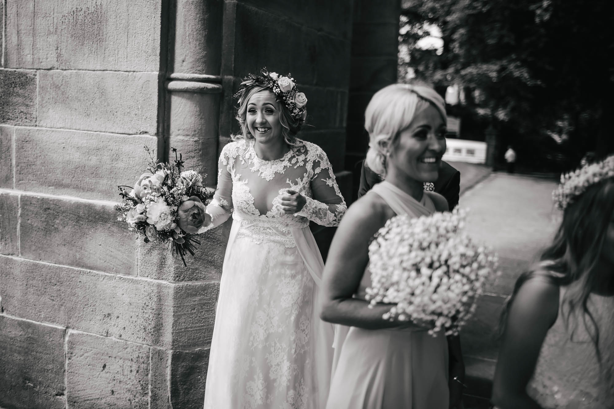 Bride laughing outside the church on her wedding day