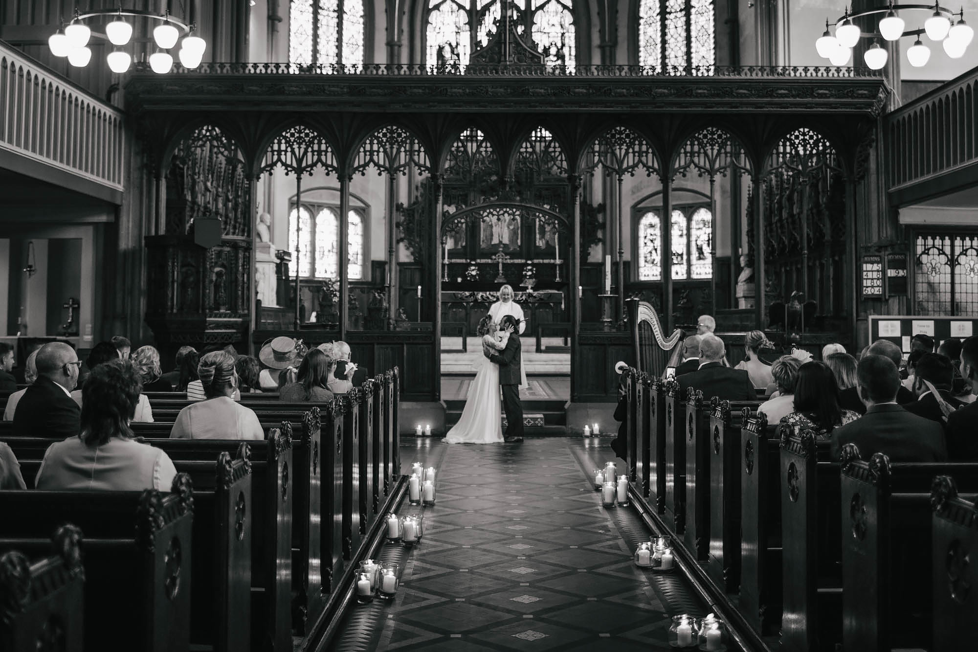 Bride and groom share their first kiss at the church on their wedding day