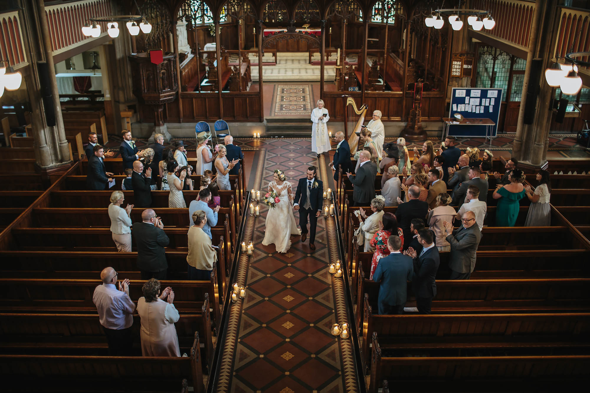 Bride and groom walk down the church aisle as a married couple