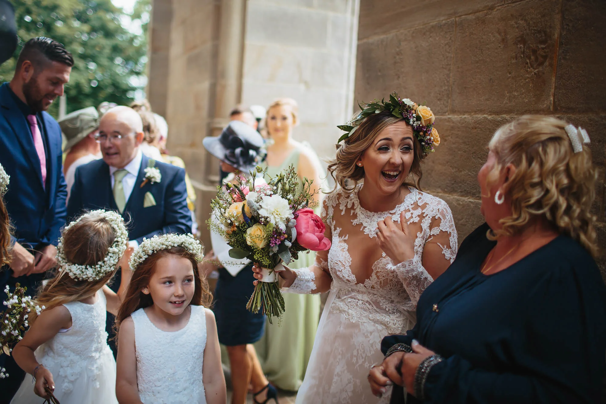 Bride laughing outside the church at her wedding