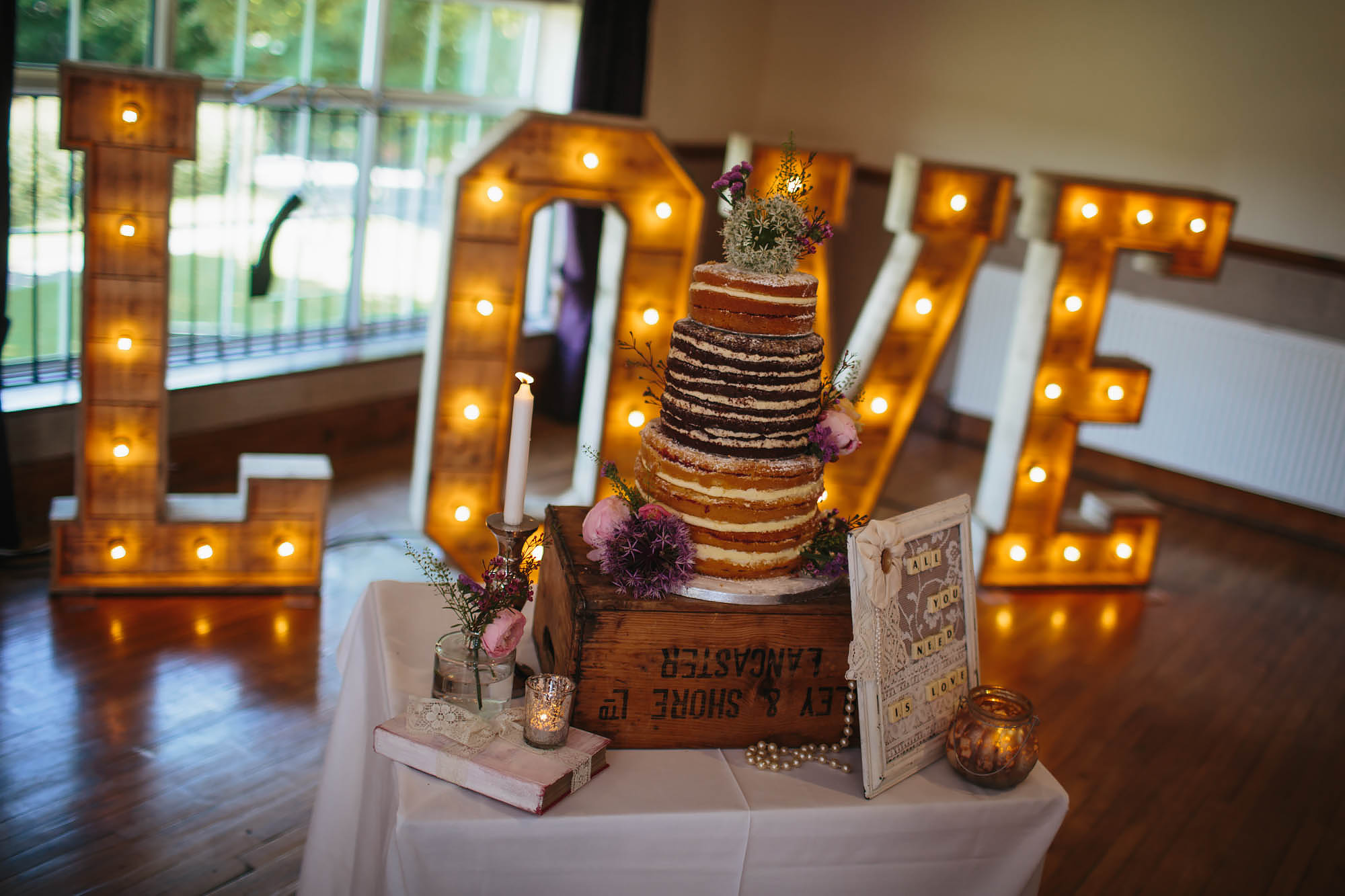 Wedding cake in front of love sign