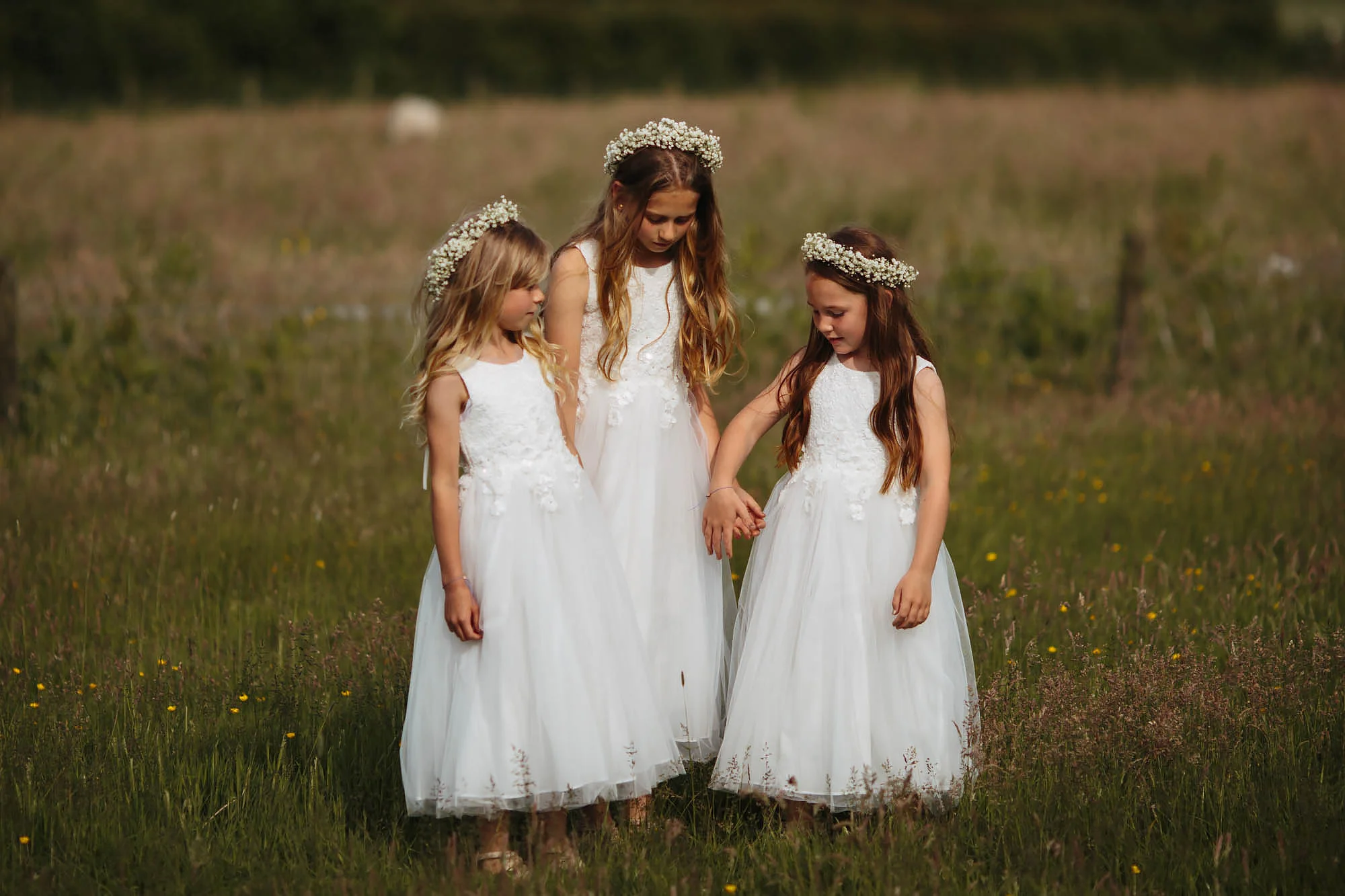 Bridesmaids holding hands at a wedding in Manchester