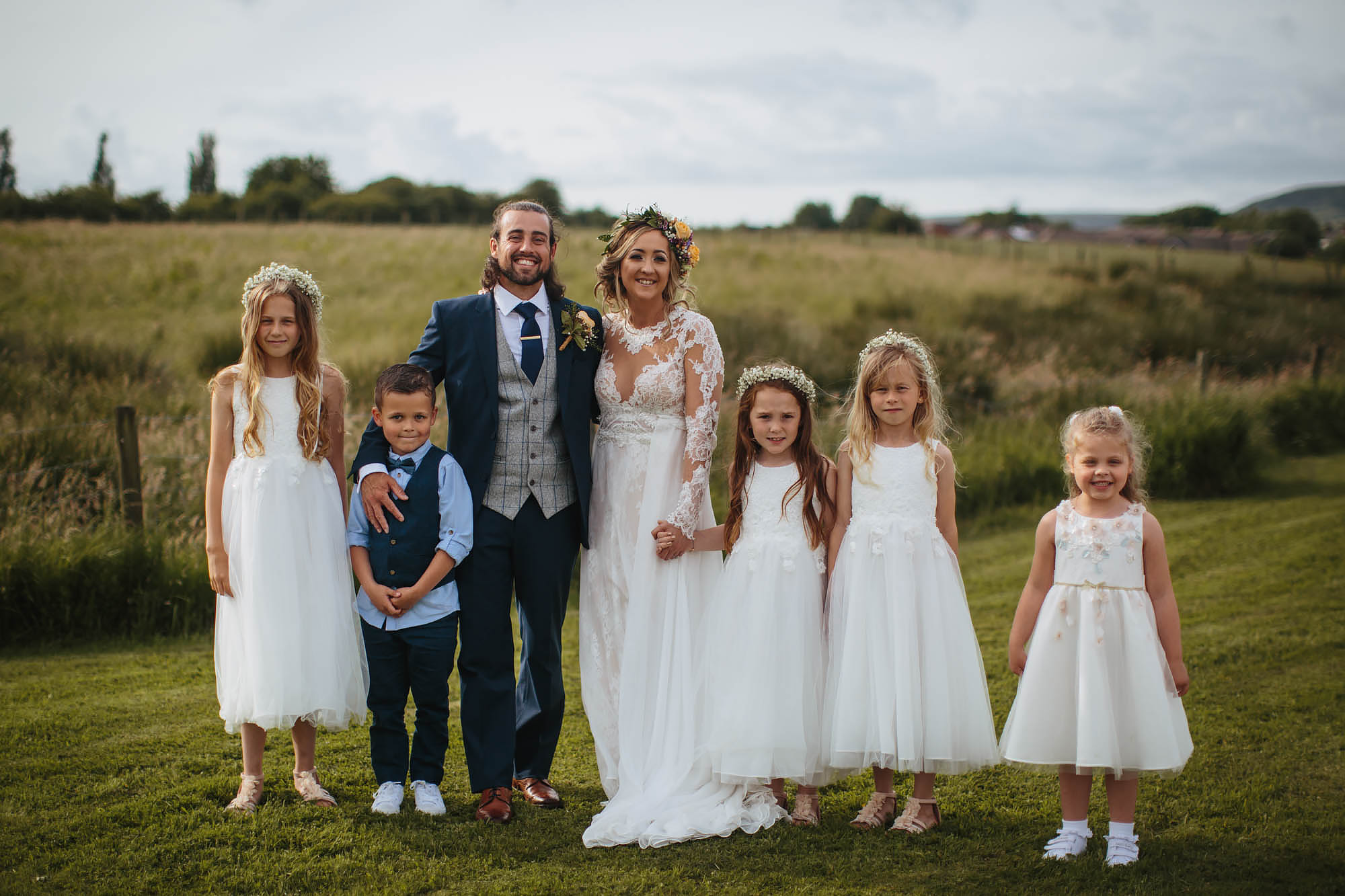 Bride groom and bridesmaids pose for a photo at a wedding