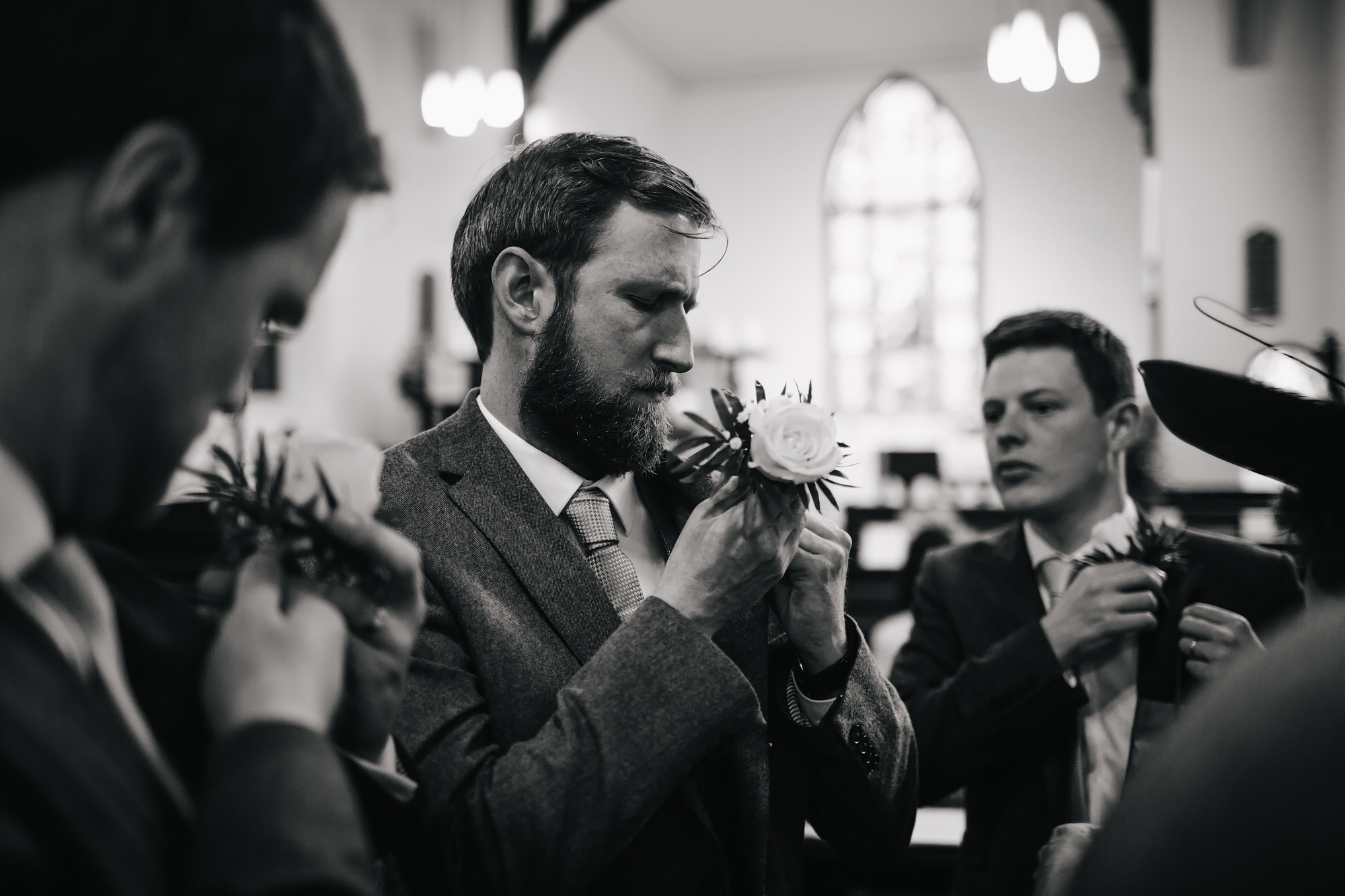 Groomsmen putting in their buttonholes in Lancashire