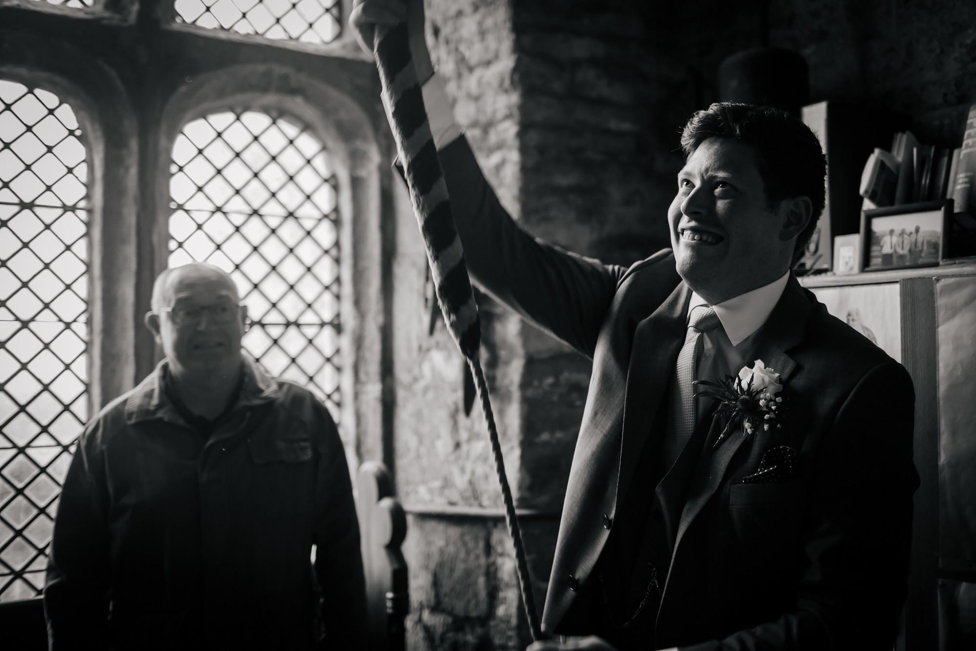 Groom ringing the church bell on his wedding day