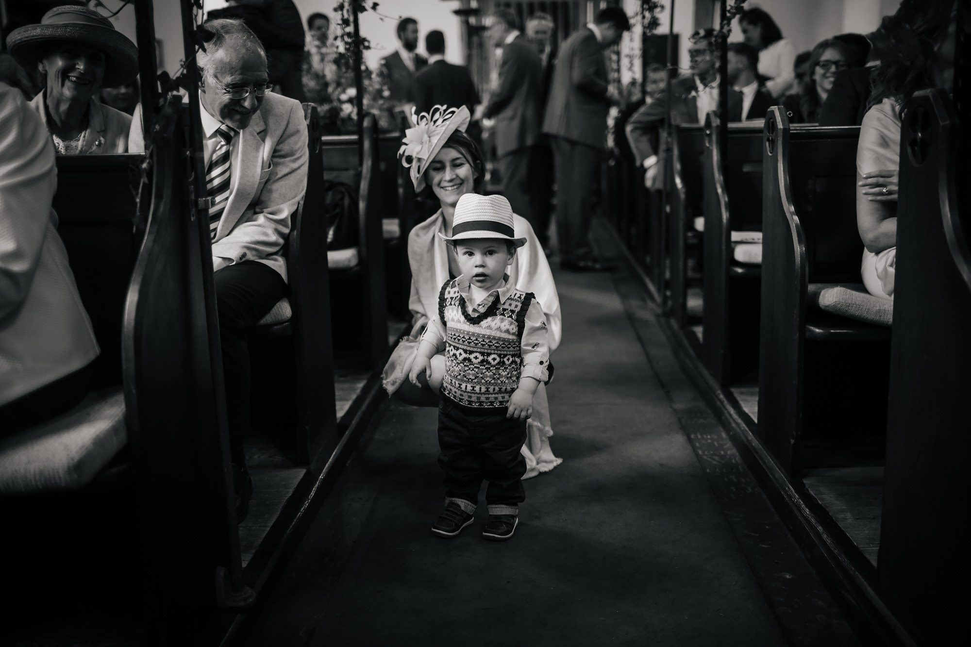 Boy with a hat in the church aisle during the wedding