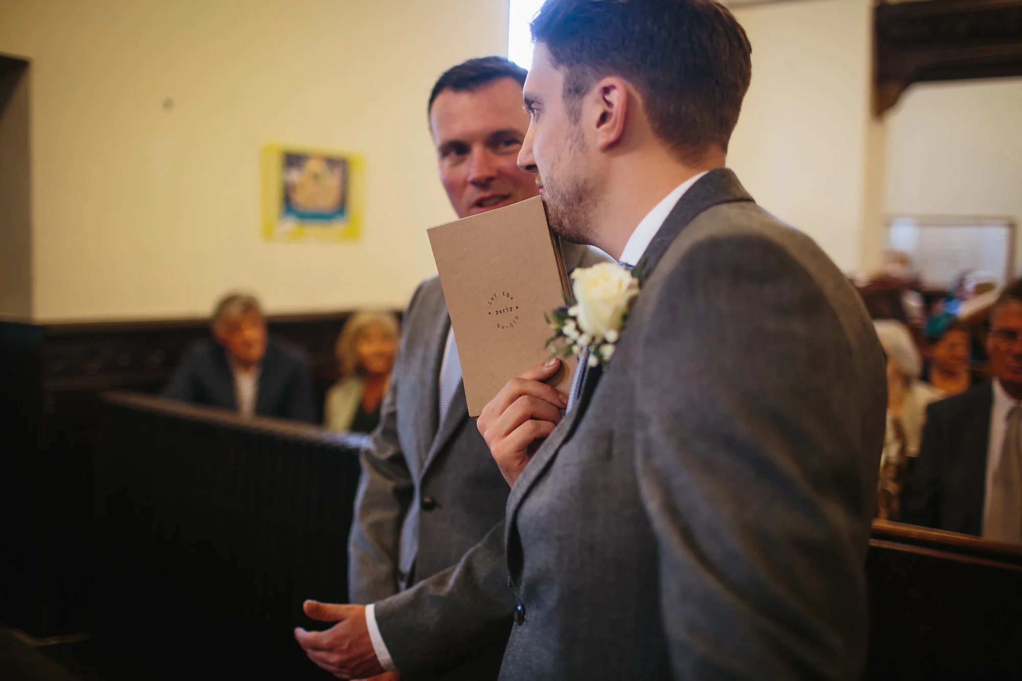 Ushers with order of service at the church wedding