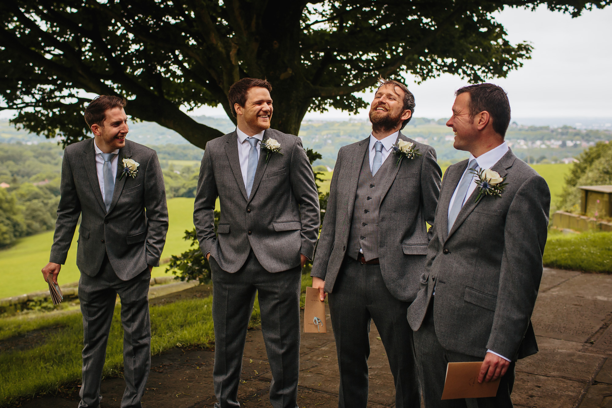 Groomsmen and ushers laughing outside the church
