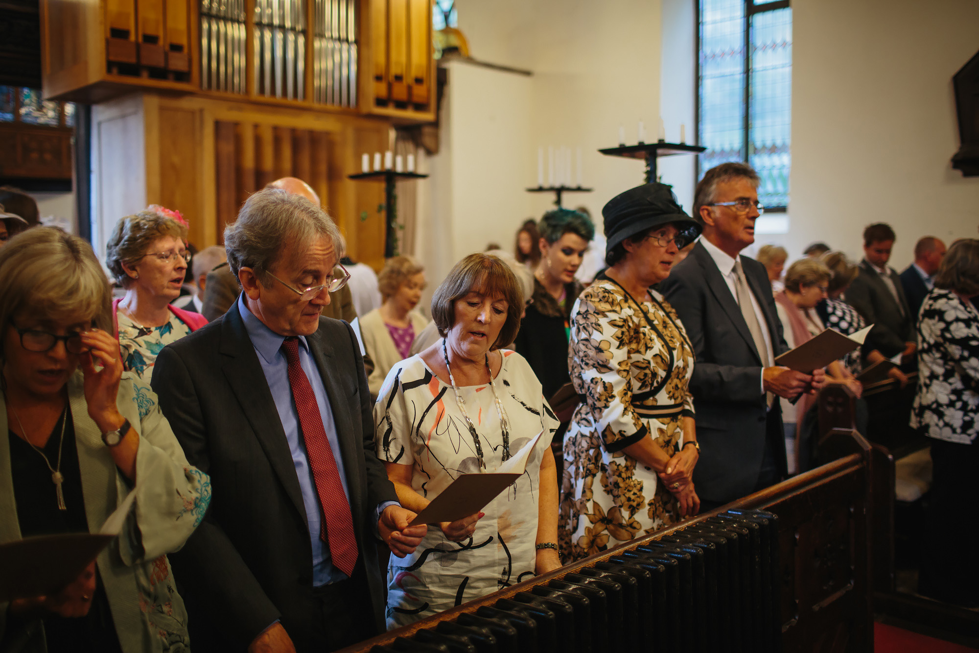 Wedding guests singing hymns in the church ceremony