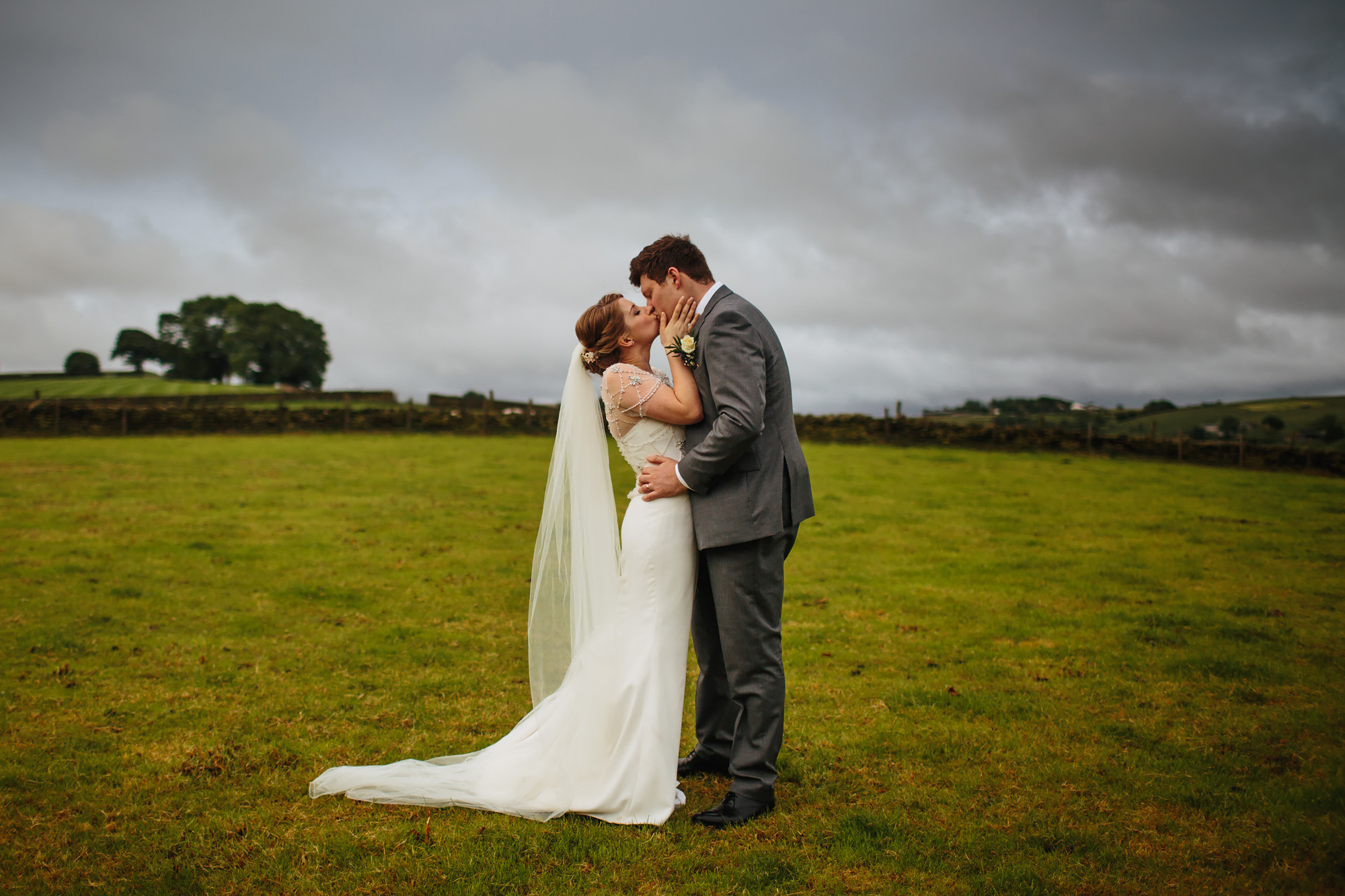 Bride and groom kissing on their wedding day in Lancashire