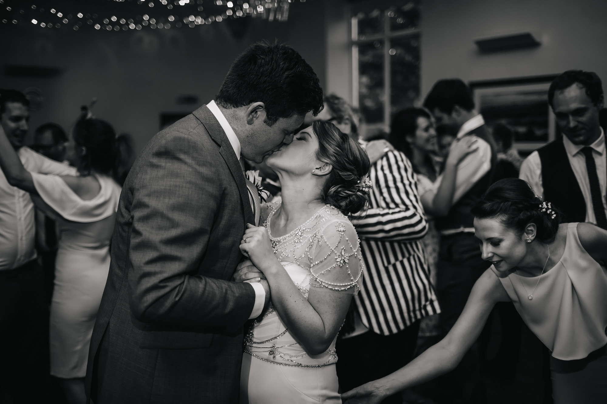 Bride and groom kiss during their first dance at their wedding