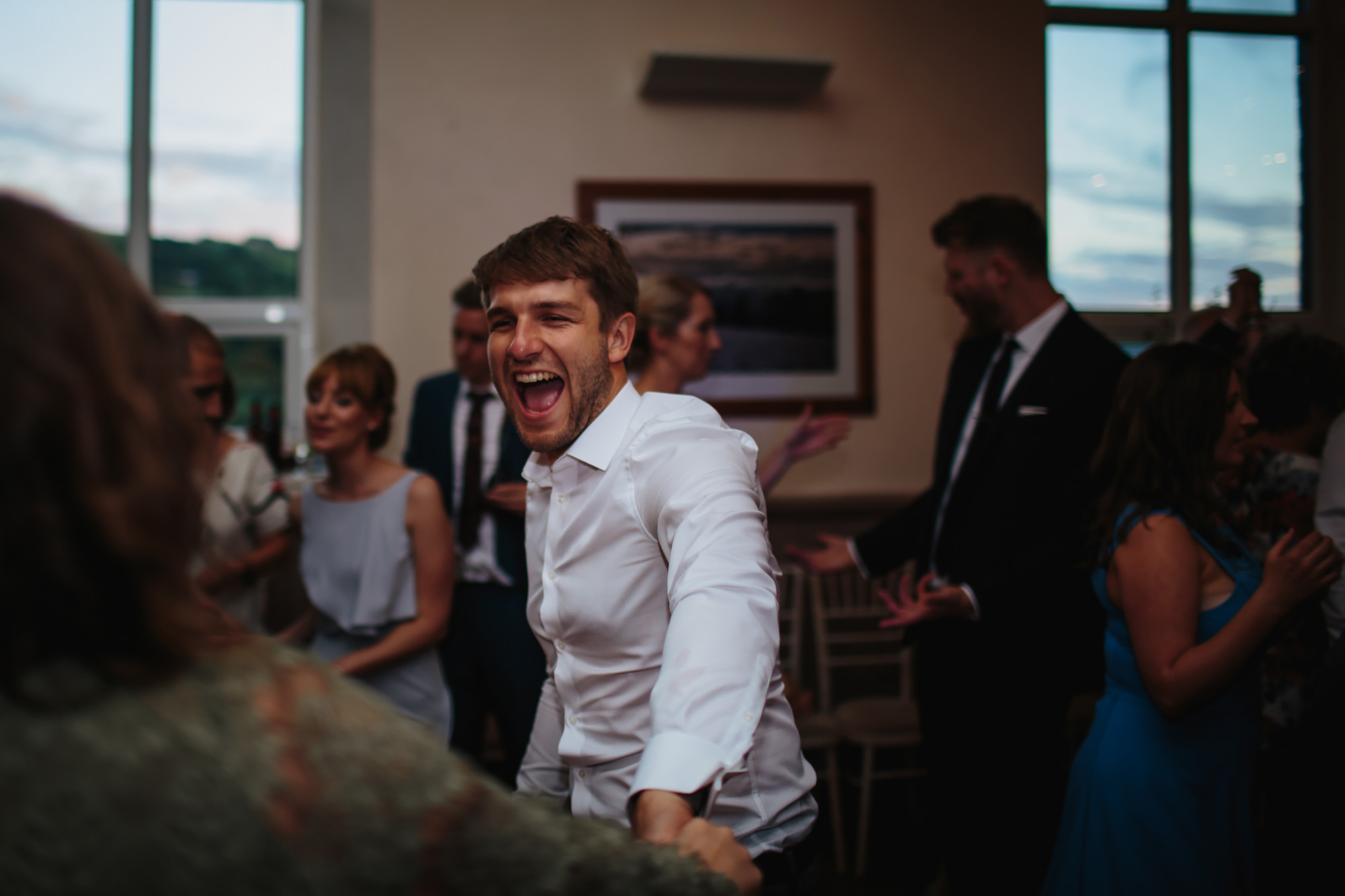 Guests laughing and dancing at a wedding