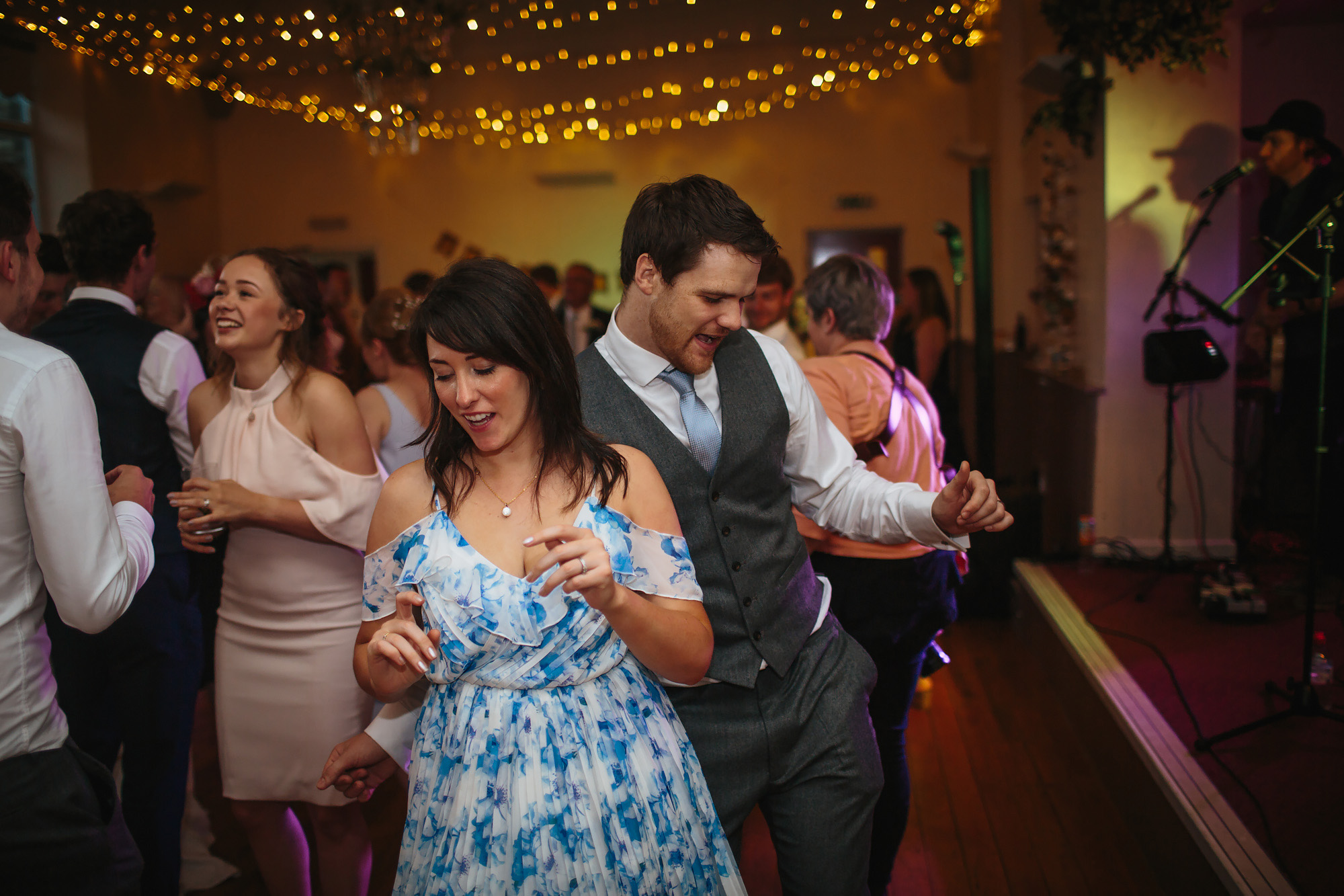 Guests dancing to a live band at a wedding